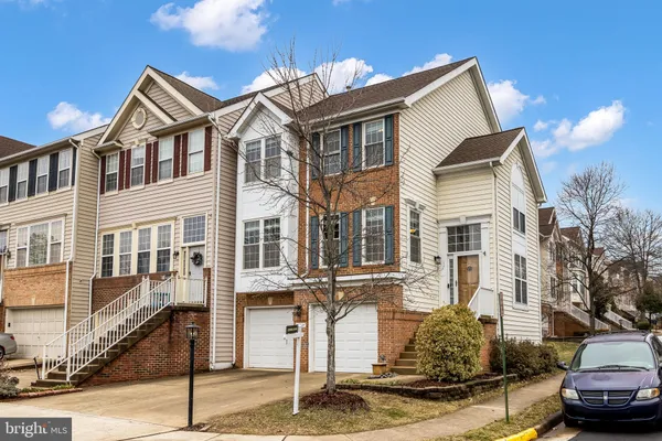 a front view of a house with a street