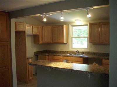 106 Seabrook Road Hyannis, MA 02601 - Photo 3 of 10 a kitchen with stainless steel appliances granite countertop a sink a stove and a refrigerator