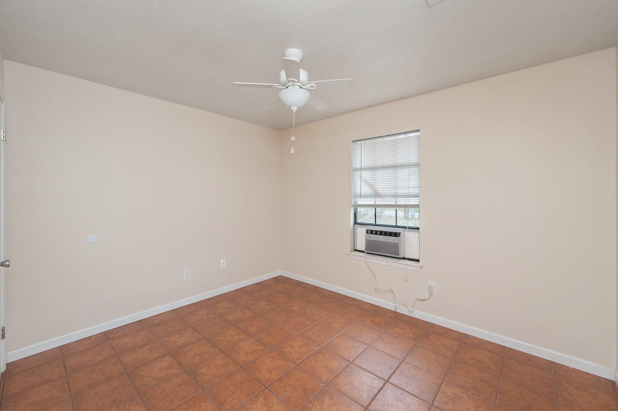 5369 Pecos Pass Gulf Breeze, FL 32563 - Photo 11 of 26 an empty room with chandelier fan and windows