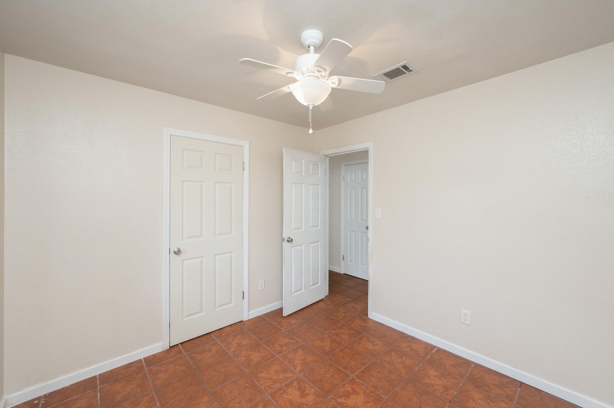 5369 Pecos Pass Gulf Breeze, FL 32563 - Photo 12 of 26 an empty room with a chandelier fan and closet