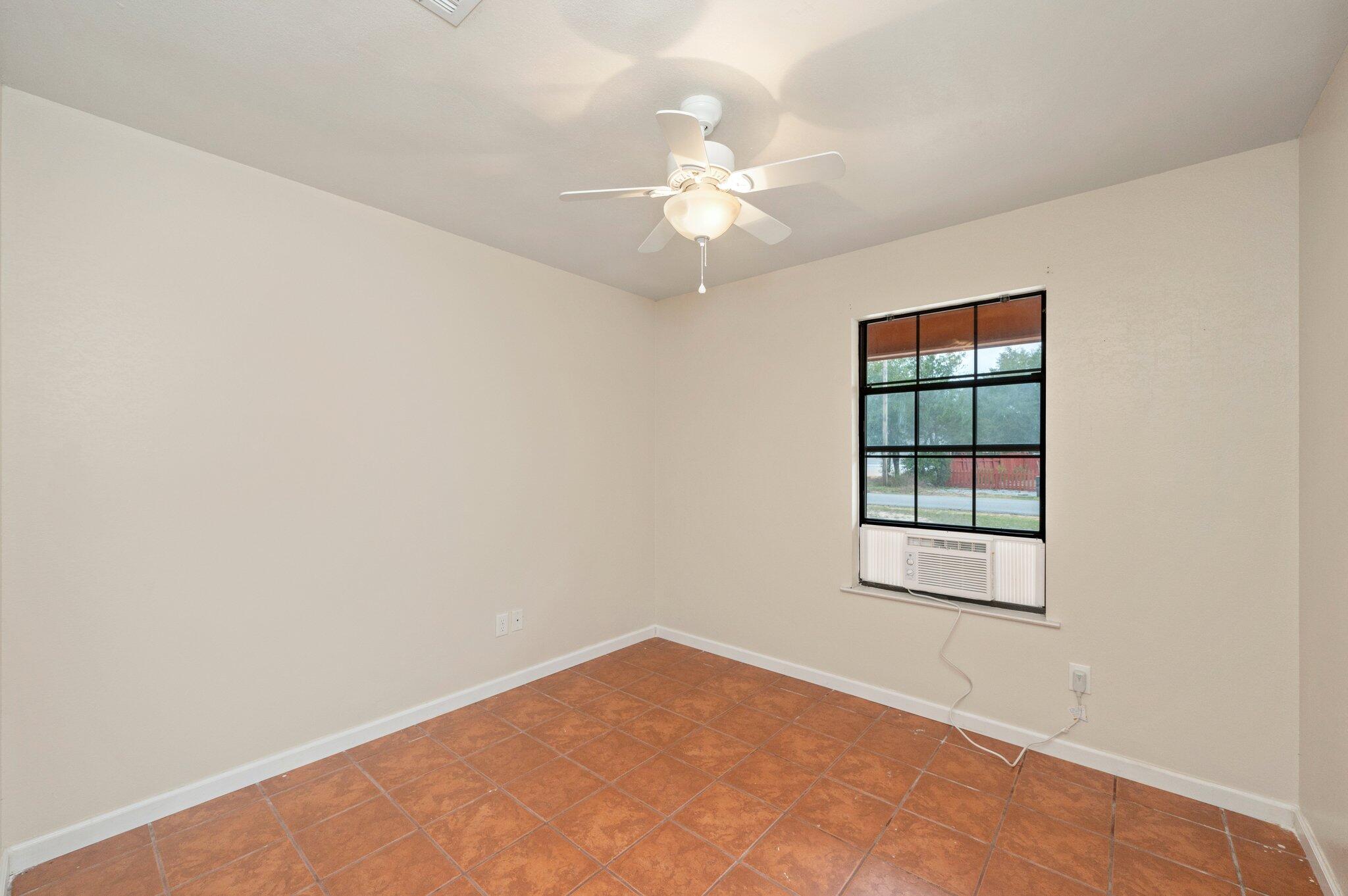 5369 Pecos Pass Gulf Breeze, FL 32563 - Photo 13 of 26 an empty room with windows and chandelier fan
