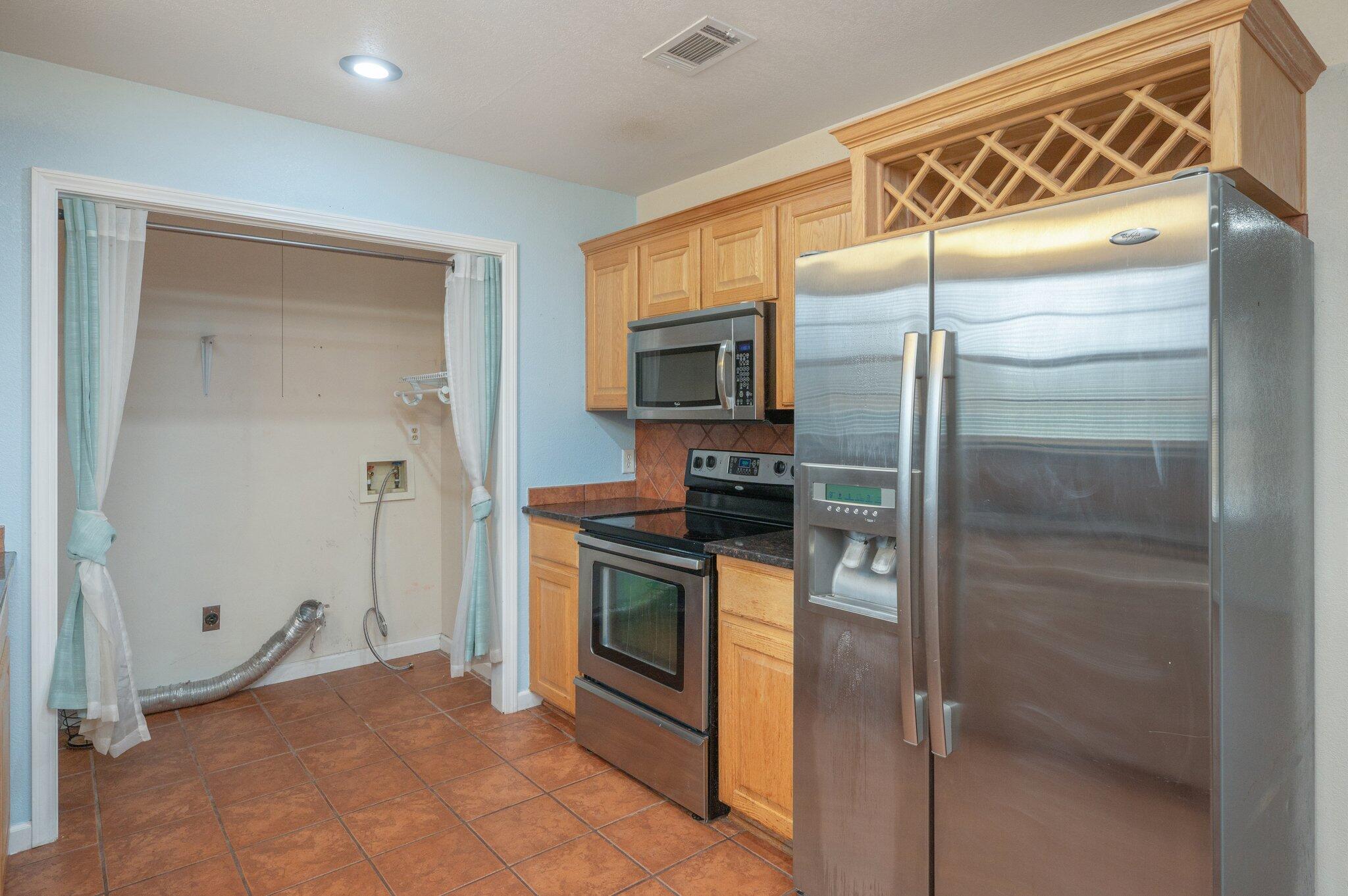 5369 Pecos Pass Gulf Breeze, FL 32563 - Photo 18 of 26 a kitchen with a refrigerator and a sink