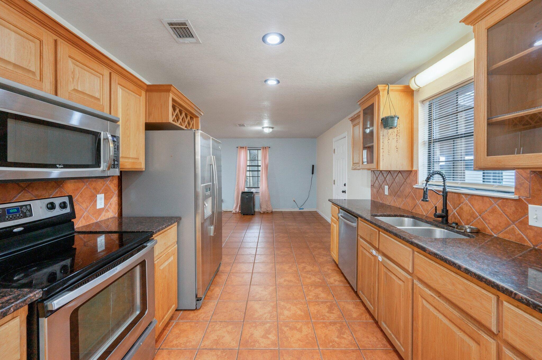 5369 Pecos Pass Gulf Breeze, FL 32563 - Photo 2 of 26 a large kitchen with stainless steel appliances granite countertop a lot of counter space and a sink