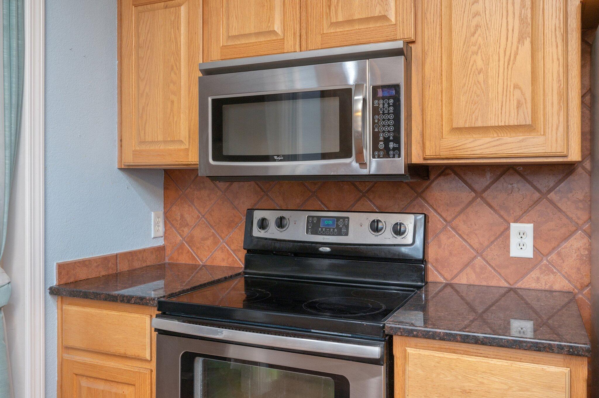 5369 Pecos Pass Gulf Breeze, FL 32563 - Photo 26 of 26 a kitchen with a stove and a microwave