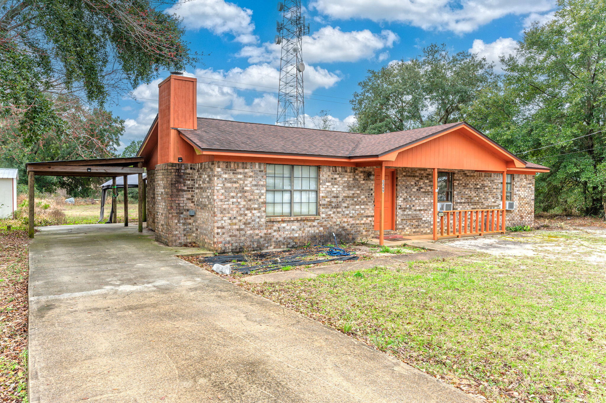 5369 Pecos Pass Gulf Breeze, FL 32563 - Photo 4 of 26 a front view of a house with a yard