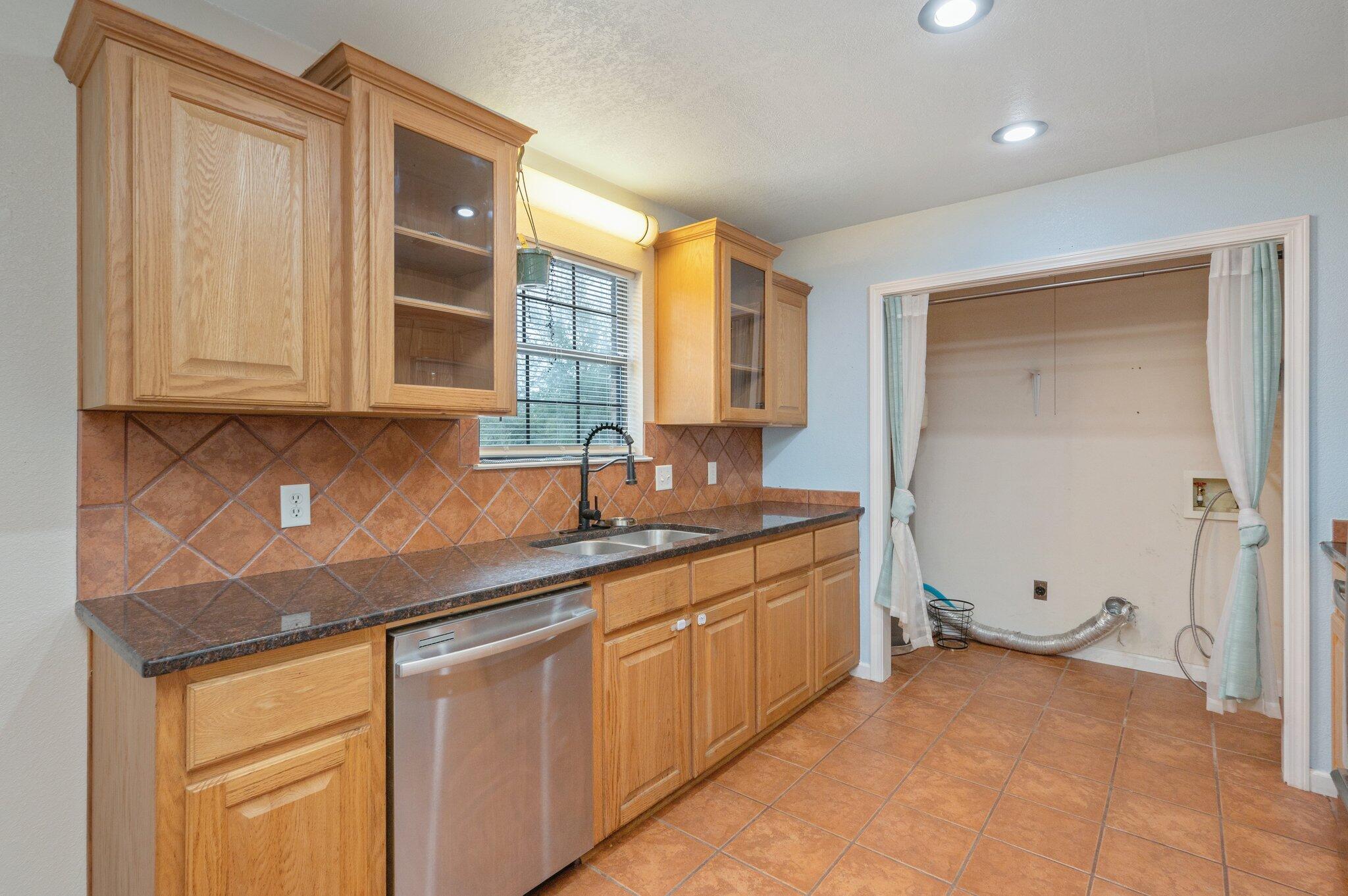5369 Pecos Pass Gulf Breeze, FL 32563 - Photo 7 of 26 a kitchen with stainless steel appliances granite countertop a sink and cabinets with wooden floor