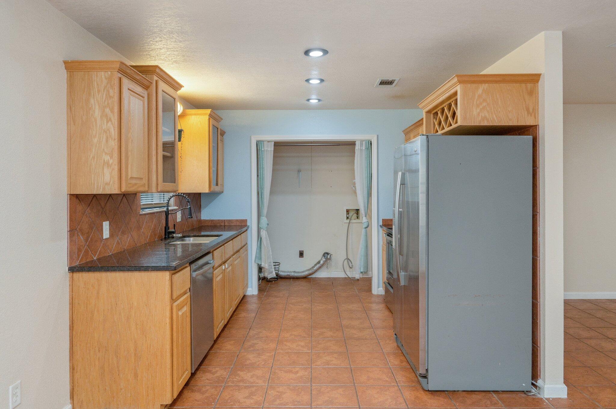 5369 Pecos Pass Gulf Breeze, FL 32563 - Photo 8 of 26 a view of a kitchen with stainless steel appliances granite countertop a refrigerator and a sink