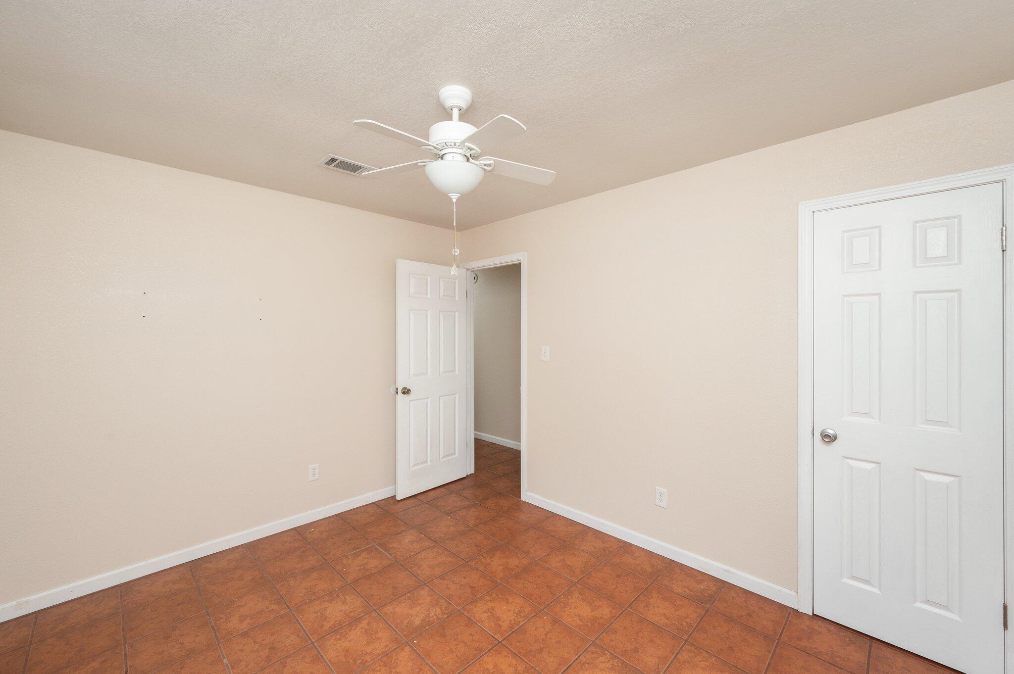 5369 Pecos Pass Gulf Breeze, FL 32563 - Photo 10 of 26 an empty room with a ceiling fan and a window