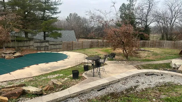 a view of a backyard with table and chairs