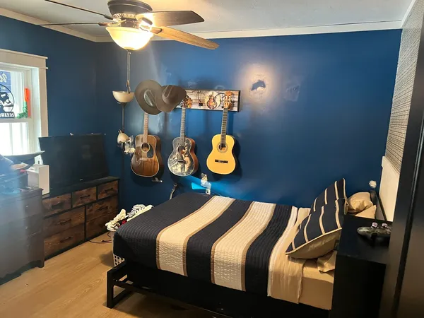a bedroom with a bed and a chandelier