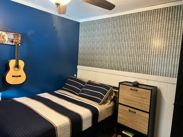 a bedroom with a bed and a chandelier