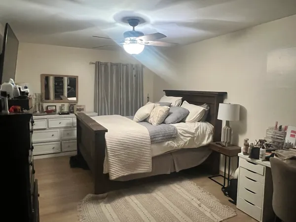 a bedroom with a bed and a chandelier