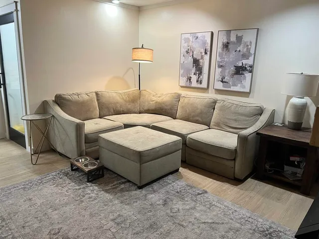 a living room with furniture and a lamp