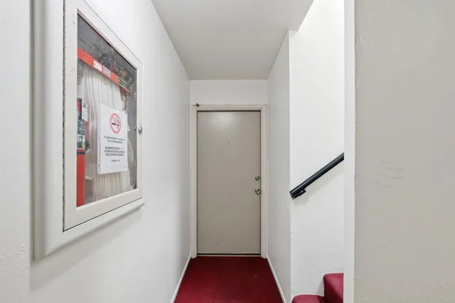 a view of a hallway with paintings on the wall