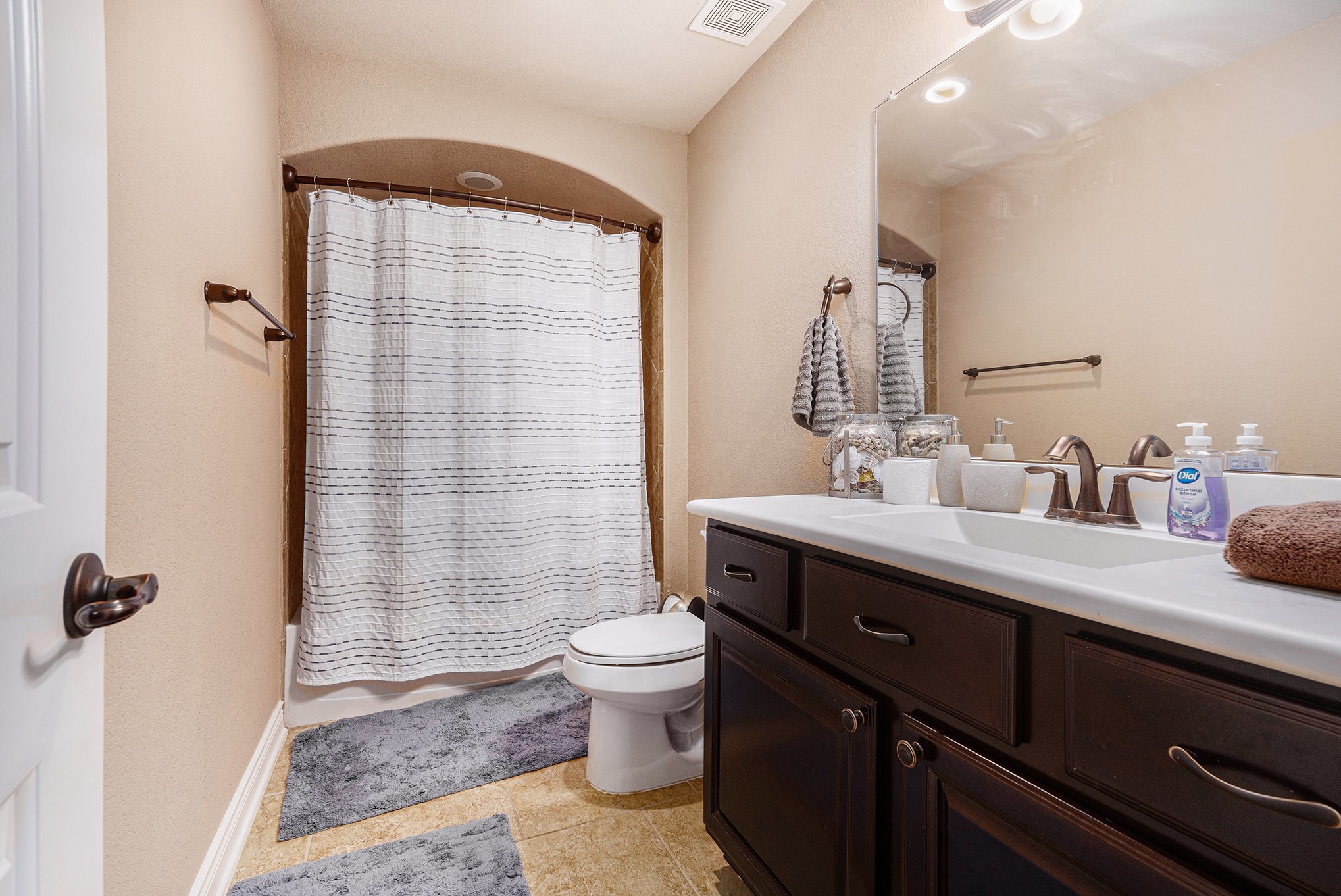 9039 Centennial Drive Conroe, TX 77384 - Photo 12 of 16 a bathroom with a double vanity sink toilet and shower