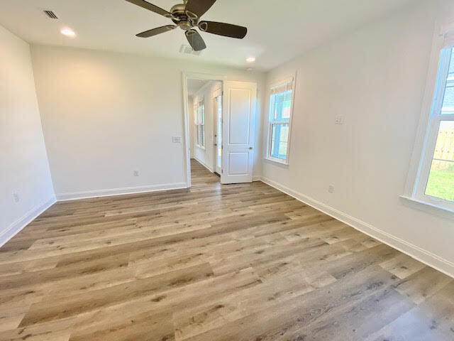 25 Cambium Ct Inlet Beach Inlet Beach, FL 32461 - Photo 13 of 29 an empty room with wooden floor fan and windows