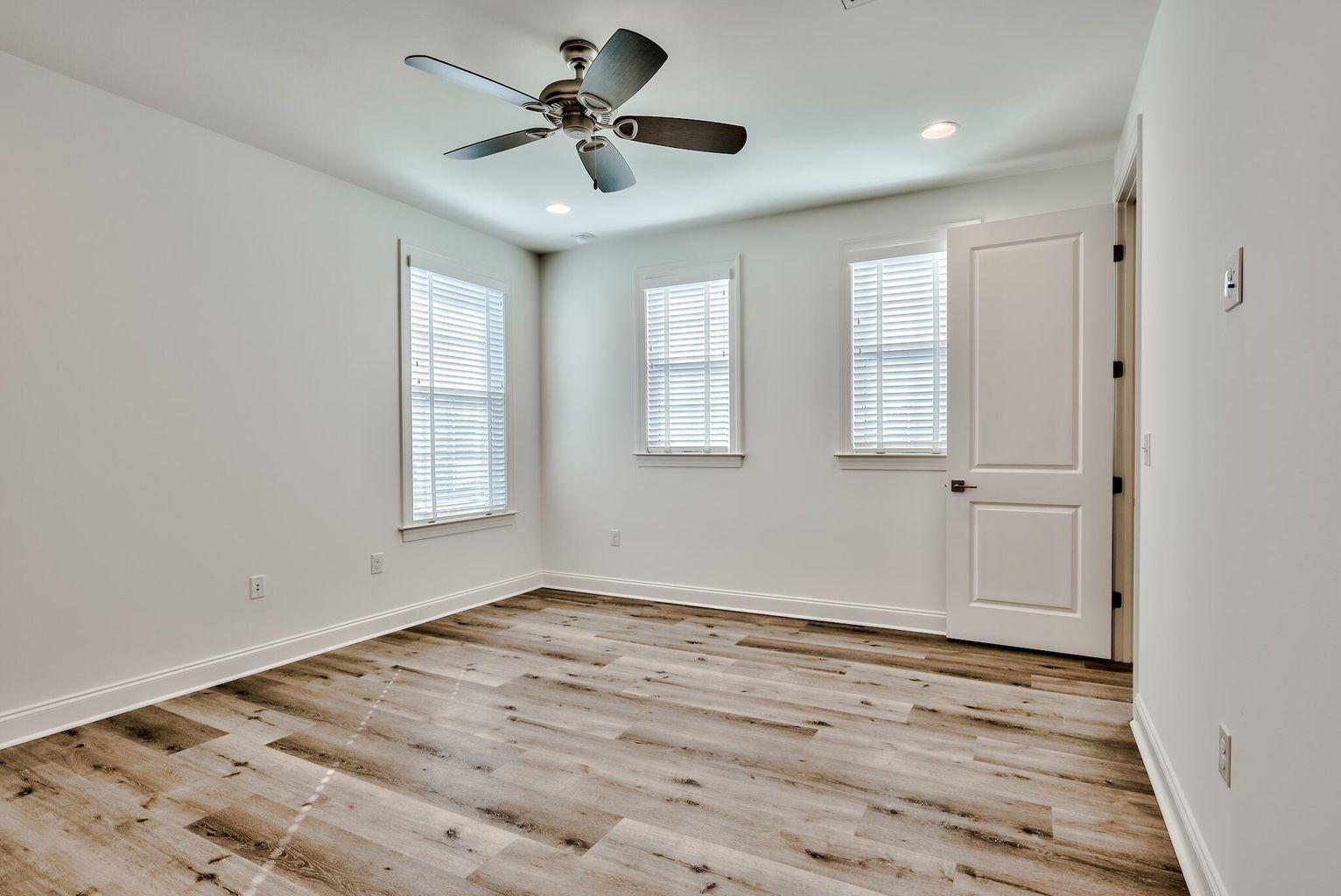 25 Cambium Ct Inlet Beach Inlet Beach, FL 32461 - Photo 20 of 29 a view of an empty room with a window and wooden floor