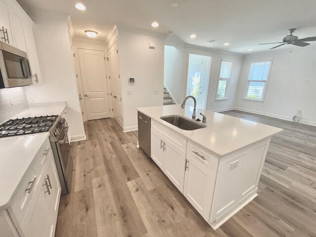 25 Cambium Ct Inlet Beach Inlet Beach, FL 32461 - Photo 10 of 29 a kitchen with kitchen island a sink a stove a refrigerator cabinets and living room view