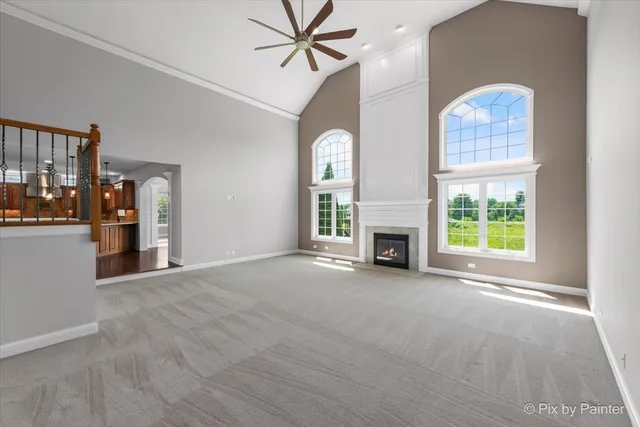 a view of a livingroom with entryway and a ceiling fan