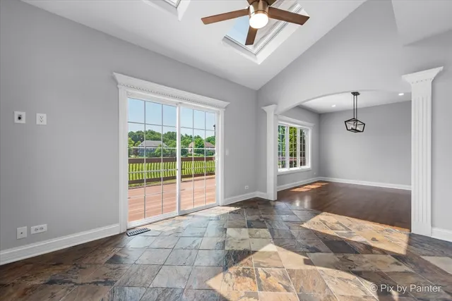 a view of an empty room with a fireplace and a window