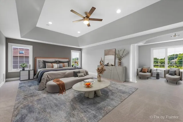 an empty room with windows and ceiling fan