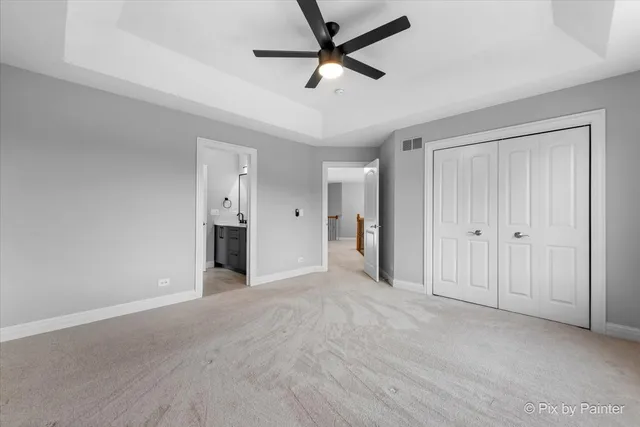 a view of a house with a yard and potted plants