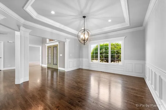 a view of wooden floor and windows in a room