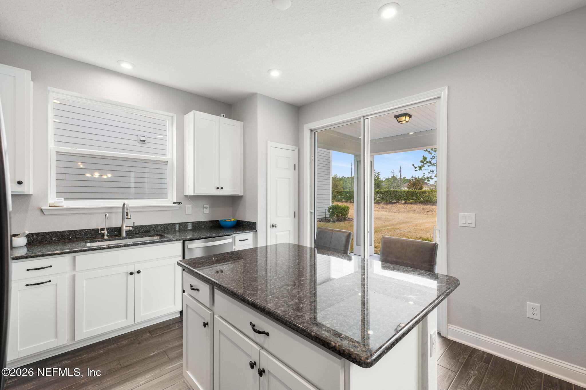 28 Focal Court St. Augustine, FL 32095 - Photo 13 of 54 a kitchen with granite countertop a sink and white cabinets