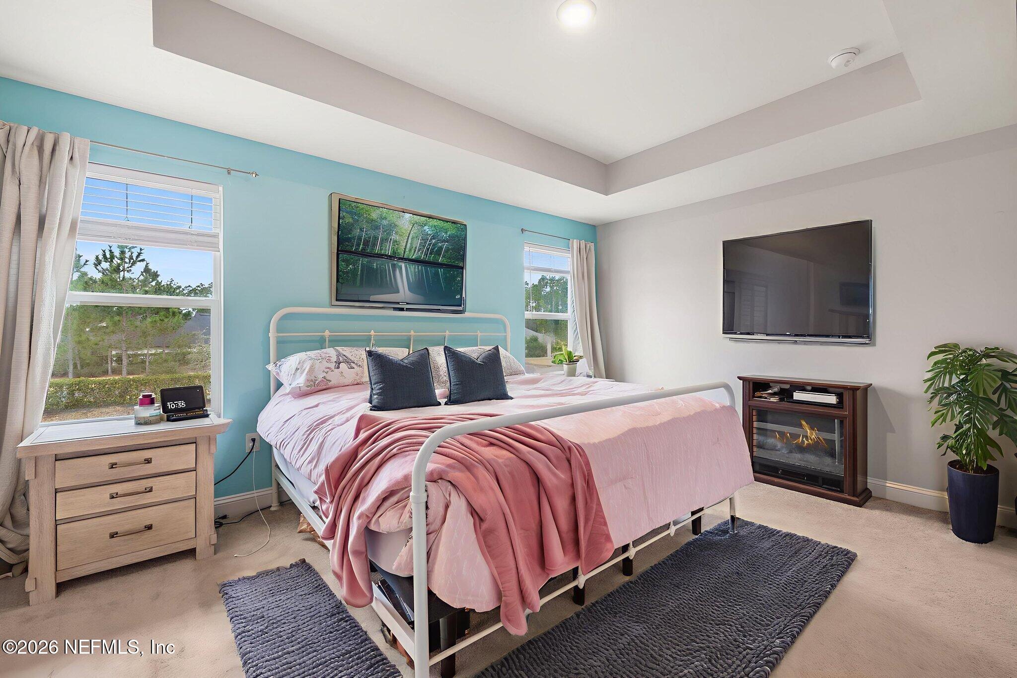 28 Focal Court St. Augustine, FL 32095 - Photo 26 of 54 a bedroom with bed a flat tv and a couch