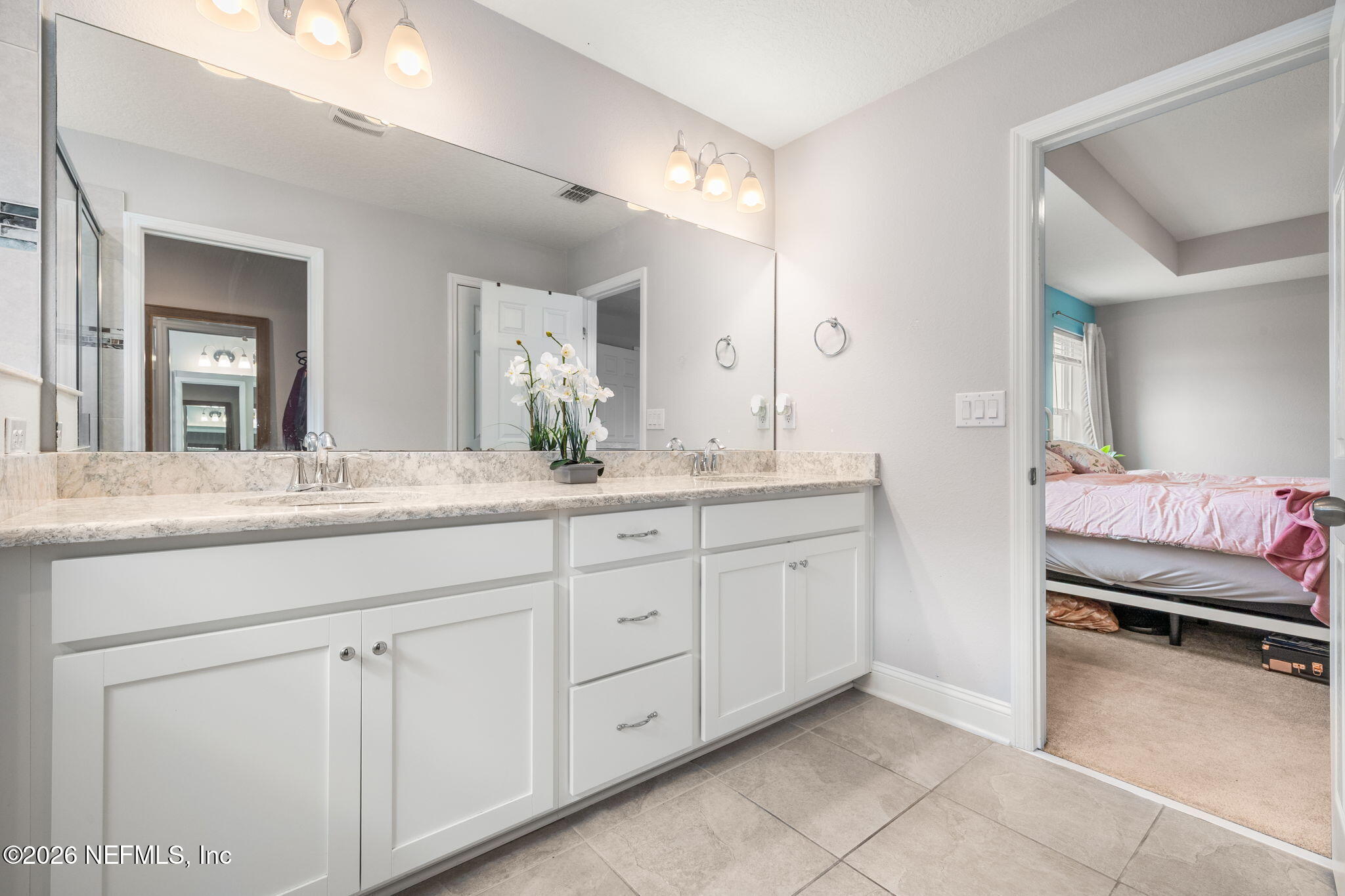 28 Focal Court St. Augustine, FL 32095 - Photo 32 of 54 a spacious bathroom with a granite countertop sink and a mirror