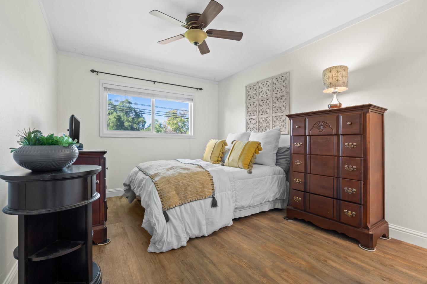 1706 Ayers Road Concord, CA 94521 - Photo 16 of 60 a bedroom with a bed a dresser and a potted plant