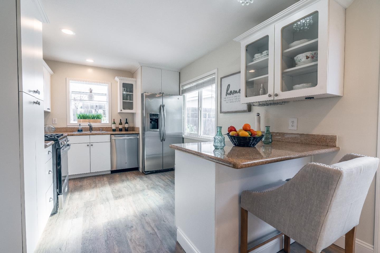 1706 Ayers Road Concord, CA 94521 - Photo 4 of 60 a kitchen with stainless steel appliances granite countertop a sink cabinets and wooden floor