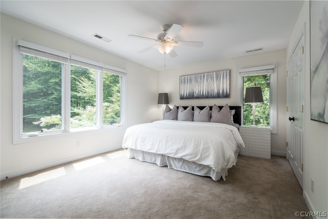 10645 Cherokee Road Richmond, VA 23235 - Photo 27 of 45 a bed sitting in a spacious bedroom next to a window