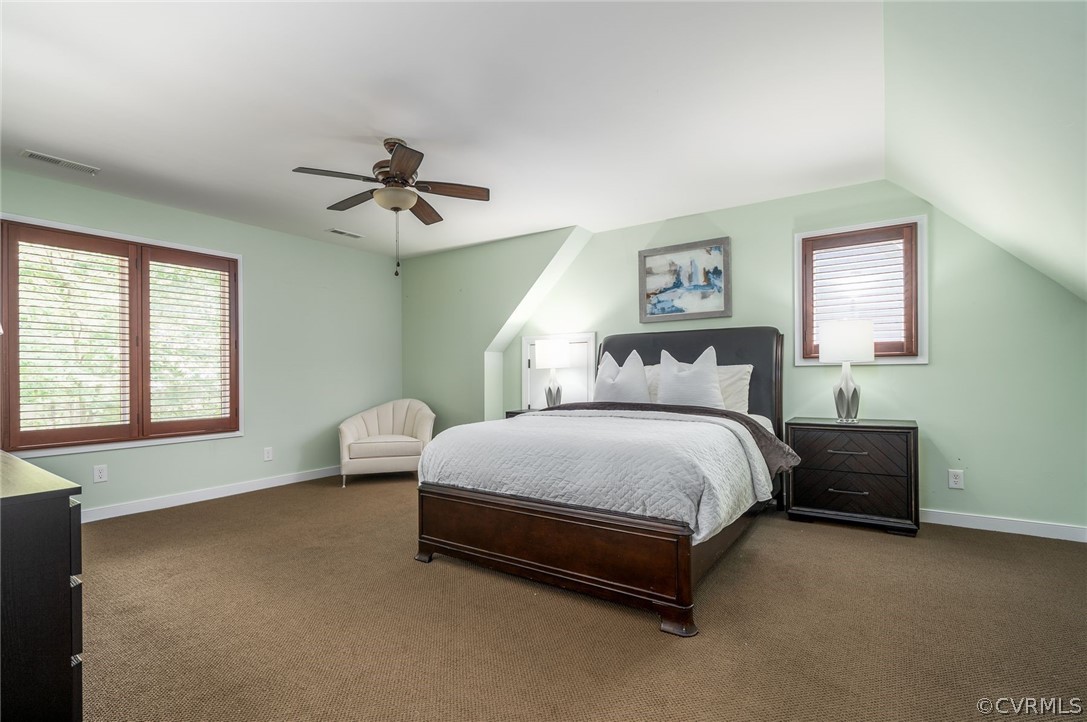 10645 Cherokee Road Richmond, VA 23235 - Photo 30 of 45 a spacious bedroom with a bed and a chandelier