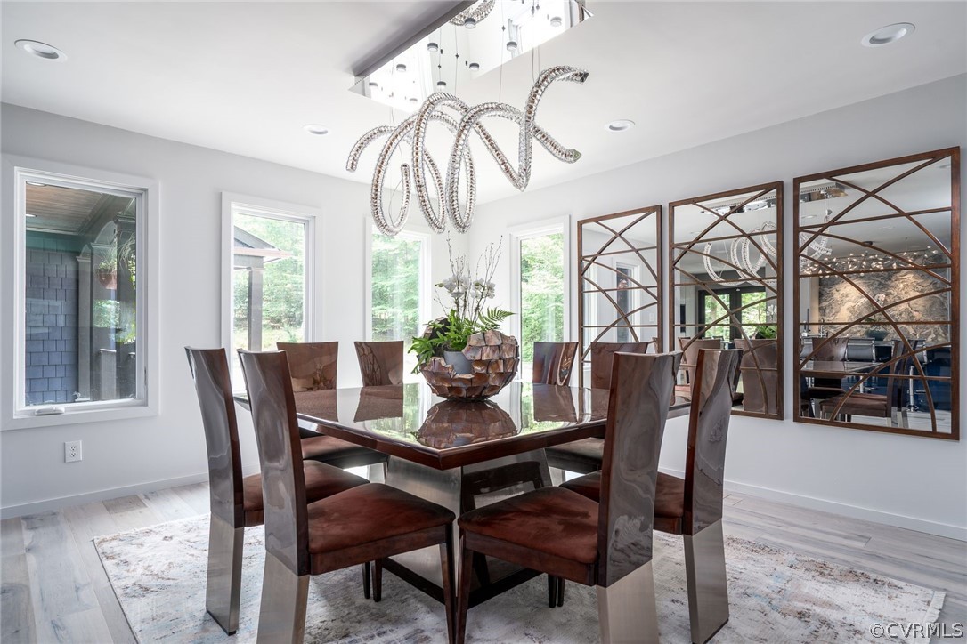 10645 Cherokee Road Richmond, VA 23235 - Photo 10 of 45 a dining room with furniture a chandelier and wooden floor
