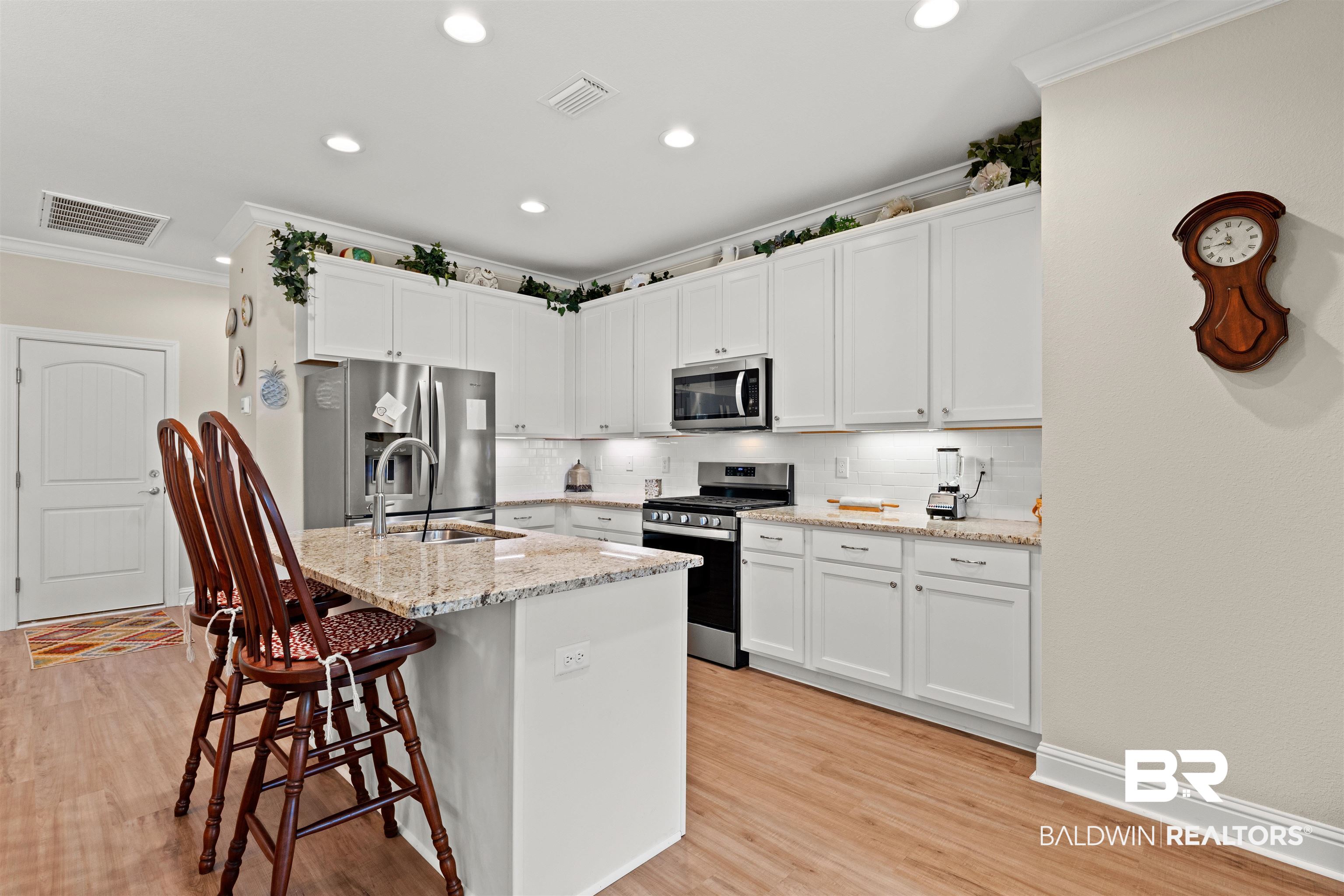 301 Holmes Avenue, Unit 301 Foley, AL 36535 - Photo 13 of 54 Kitchen with visible vents, light wood-style flooring, a sink, stainless steel appliances, and crown molding