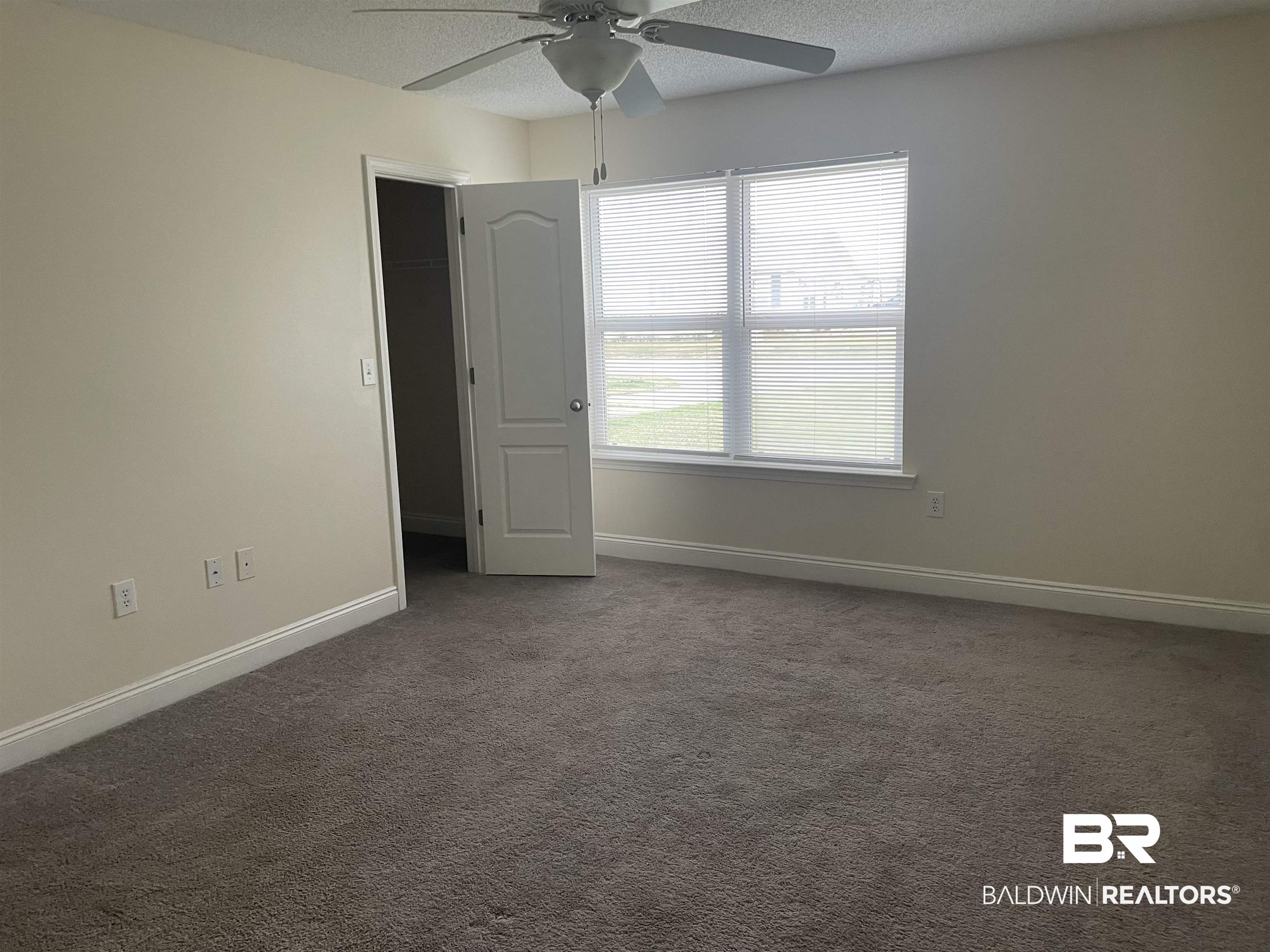 23575 Fountain Street Robertsdale, AL 36567 - Photo 5 of 19 Unfurnished room with carpet, baseboards, and a textured ceiling