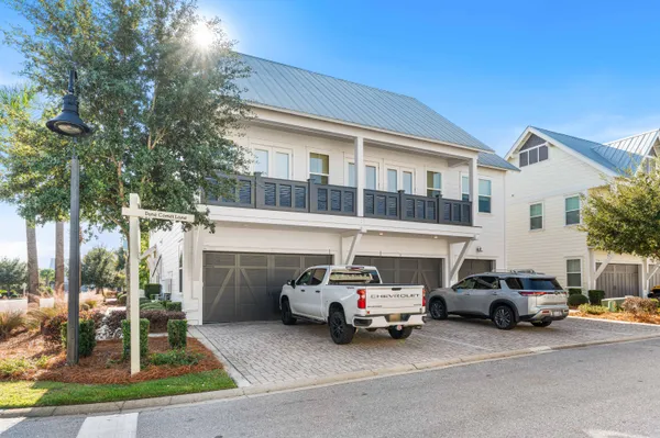 a couple of cars parked in front of a house