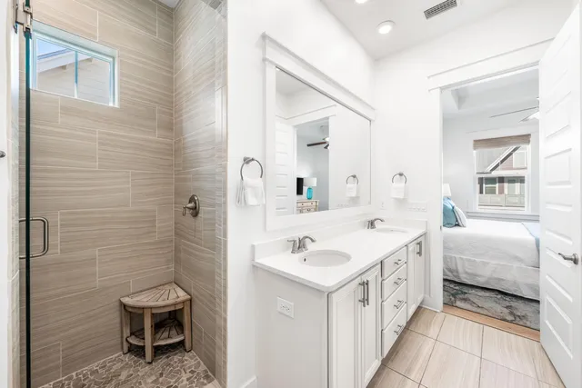 a bathroom with a double vanity sink a toilet and a mirror