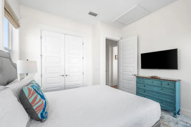 a bedroom with a bed and a flat screen tv