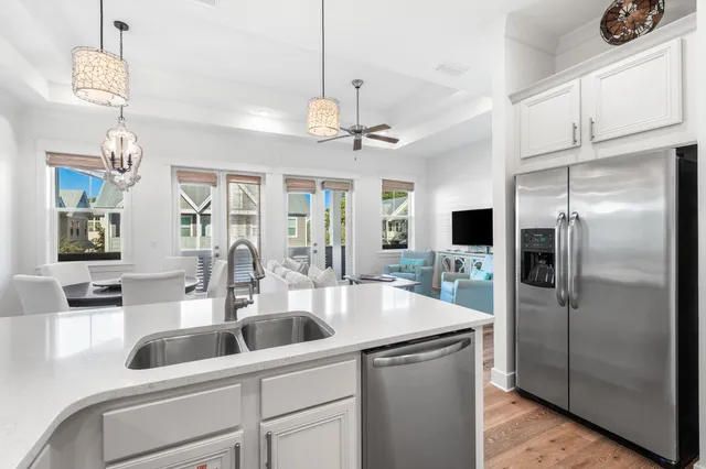 a kitchen with a refrigerator a sink and cabinets