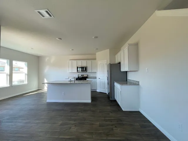 a kitchen with refrigerator and stove