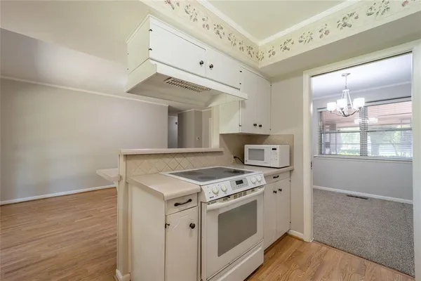 a kitchen with granite countertop a stove and a microwave oven