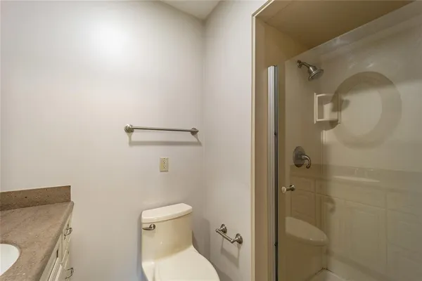a bathroom with a toilet and a shower