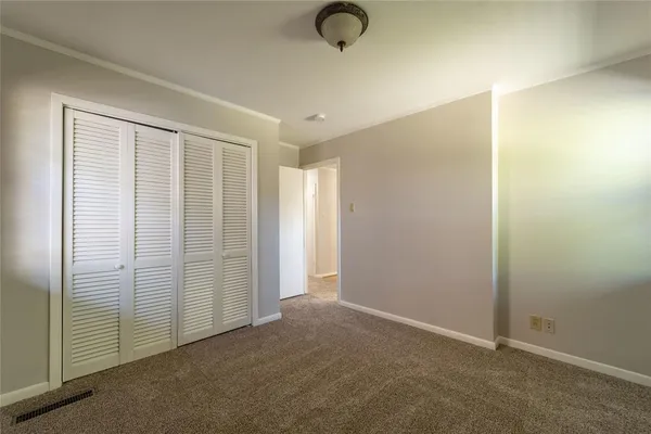 an empty room with closet area