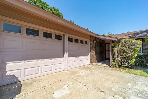 a view of house with backyard and sitting area