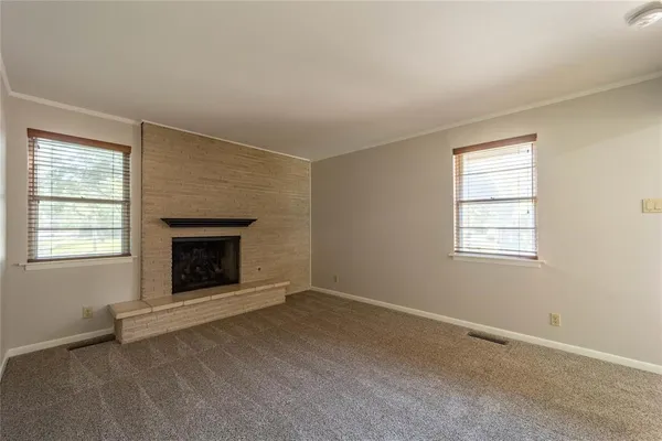 an empty room with a fireplace