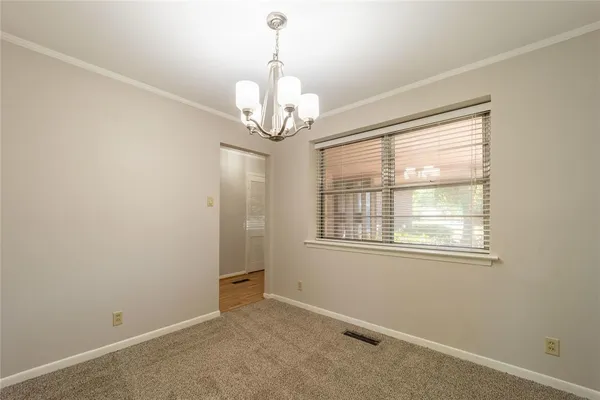 an empty room with a chandelier