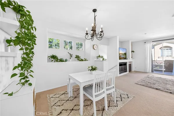 a view of a dining room with furniture and chandelier