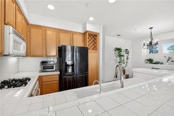 a kitchen with stainless steel appliances a refrigerator sink and cabinets